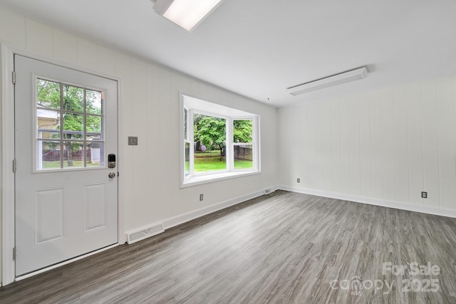 entryway featuring wood finished floors and baseboards
