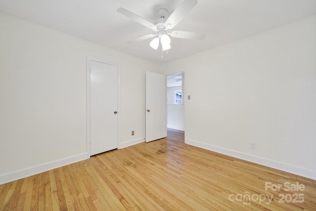 unfurnished bedroom featuring baseboards, light wood-type flooring, and a ceiling fan