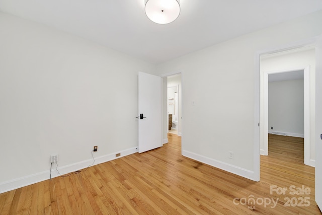 unfurnished bedroom with light wood finished floors and baseboards