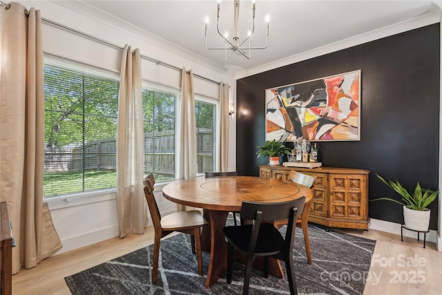 324 Elm St, Belmont, NC 28012 - dining room featuring a chandelier, wood finished floors, plenty of natural light, and crown molding