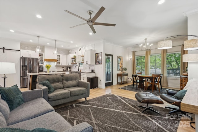 324 Elm St, Belmont, NC 28012 - living room with a ceiling fan, recessed lighting, light wood-style flooring, a chandelier, and crown molding