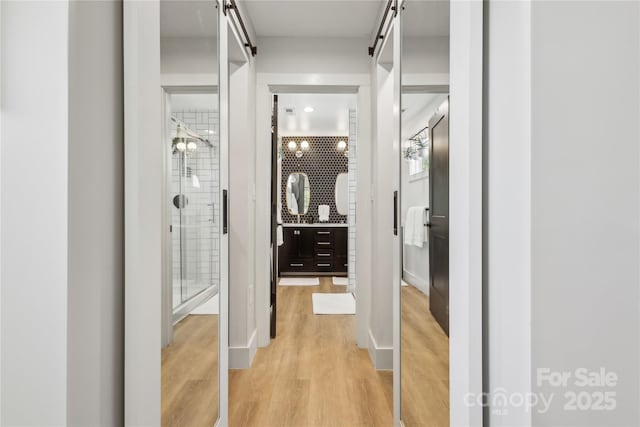 324 Elm St, Belmont, NC 28012 - hallway featuring a barn door and light wood-type flooring
