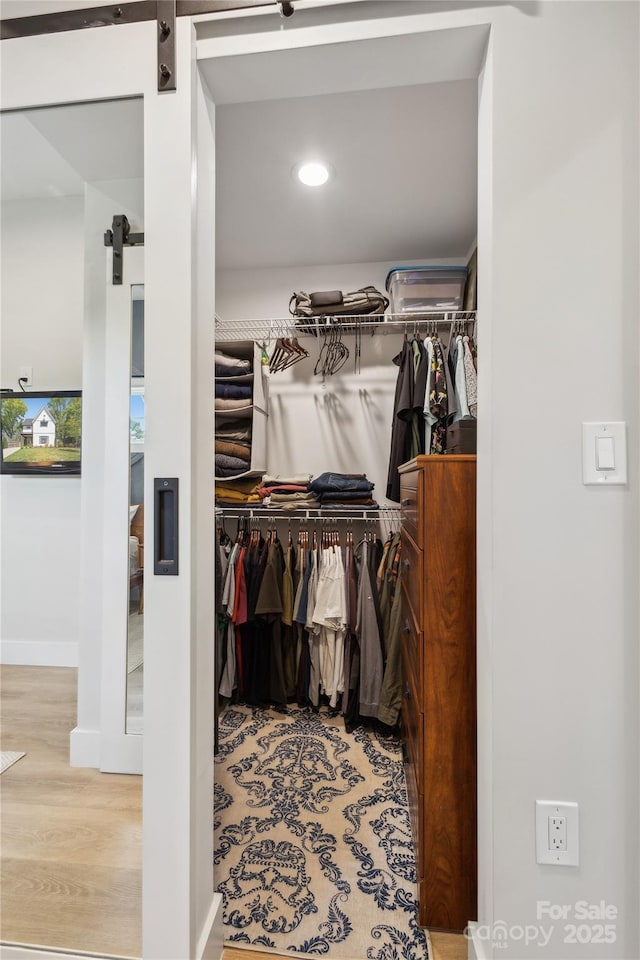 324 Elm St, Belmont, NC 28012 - spacious closet with a barn door and wood finished floors