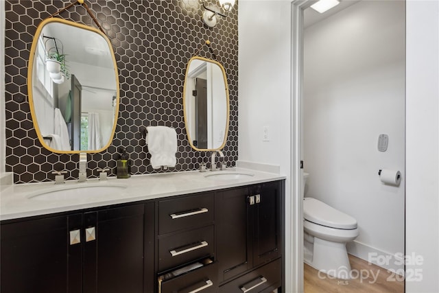 324 Elm St, Belmont, NC 28012 - full bathroom featuring toilet, double vanity, and baseboards