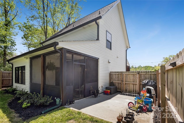 324 Elm St, Belmont, NC 28012 - rear view of house with a sunroom, a patio, a fenced backyard, and a gate