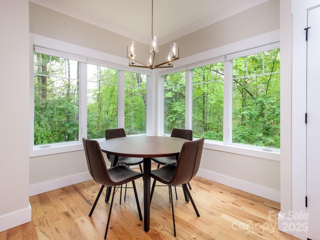 dining room with baseboards, a chandelier, and plenty of natural light