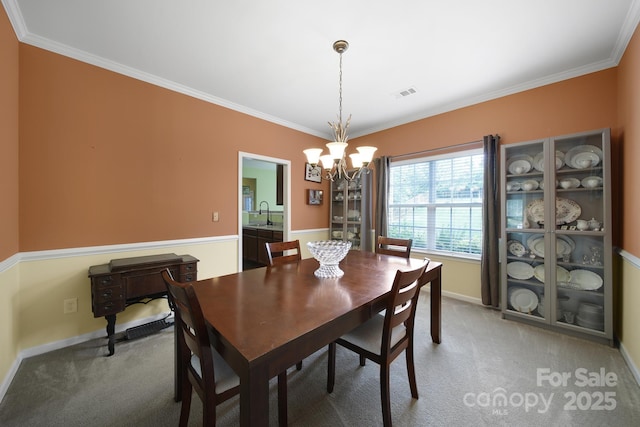 2017 White Cedar Ln, Waxhaw, NC 28173 - dining room with a chandelier, crown molding, carpet flooring, and baseboards
