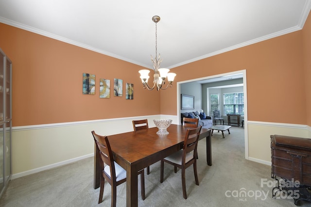 2017 White Cedar Ln, Waxhaw, NC 28173 - dining space with crown molding, light colored carpet, a chandelier, and baseboards