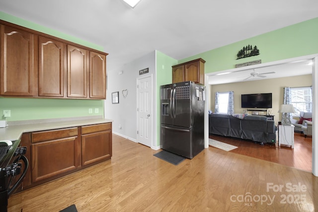 2017 White Cedar Ln, Waxhaw, NC 28173 - kitchen with black appliances, light wood finished floors, light countertops, ceiling fan, and healthy amount of natural light