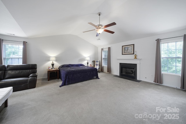 2017 White Cedar Ln, Waxhaw, NC 28173 - carpeted bedroom with vaulted ceiling, a fireplace with flush hearth, ceiling fan, and baseboards