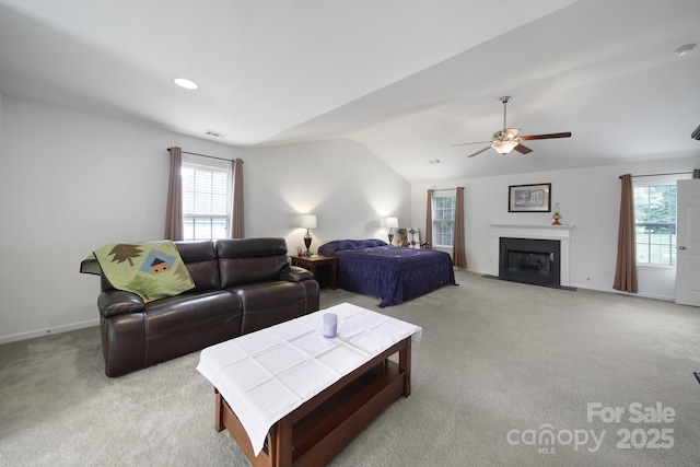 2017 White Cedar Ln, Waxhaw, NC 28173 - living room with lofted ceiling, light carpet, ceiling fan, a fireplace with flush hearth, and baseboards