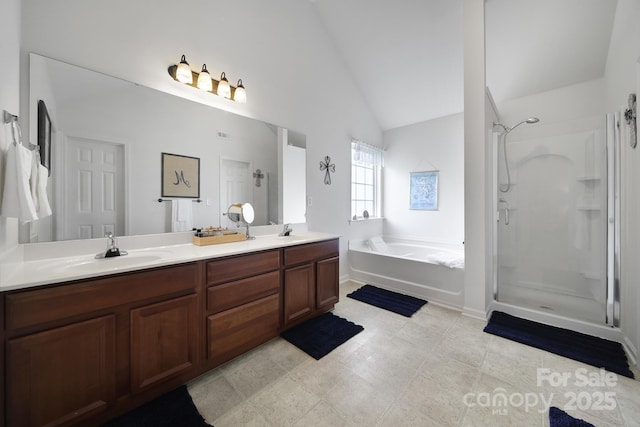 2017 White Cedar Ln, Waxhaw, NC 28173 - bathroom with a garden tub, a stall shower, double vanity, and lofted ceiling