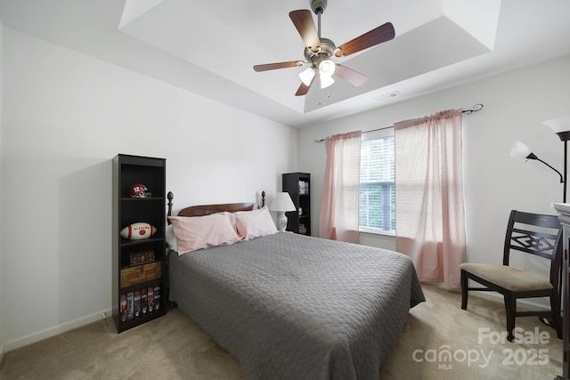 2017 White Cedar Ln, Waxhaw, NC 28173 - bedroom with light colored carpet, a raised ceiling, a ceiling fan, and baseboards