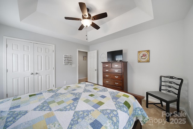 2017 White Cedar Ln, Waxhaw, NC 28173 - bedroom featuring a raised ceiling, a closet, a ceiling fan, and baseboards