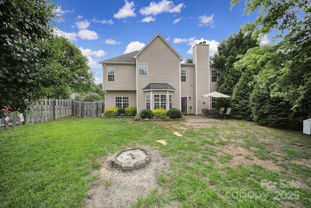 2017 White Cedar Ln, Waxhaw, NC 28173 - back of house with an outdoor fire pit, a patio area, and a chimney