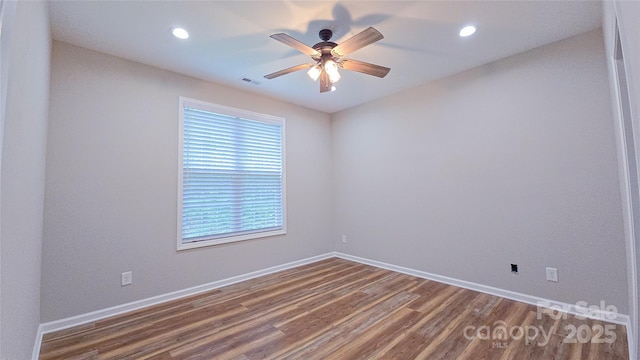 spare room with wood finished floors, ceiling fan, baseboards, and recessed lighting