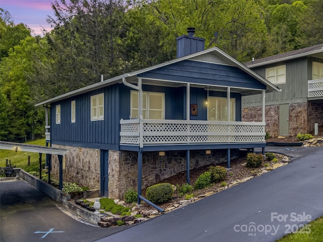 336 Stoney Ridge Loop, Maggie Valley, NC 28751 - view of front of home with stone siding, board and batten siding, and a chimney