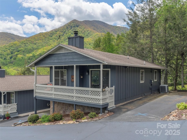 336 Stoney Ridge Loop, Maggie Valley, NC 28751 - view of front of home featuring board and batten siding, a chimney, a mountain view, and central AC