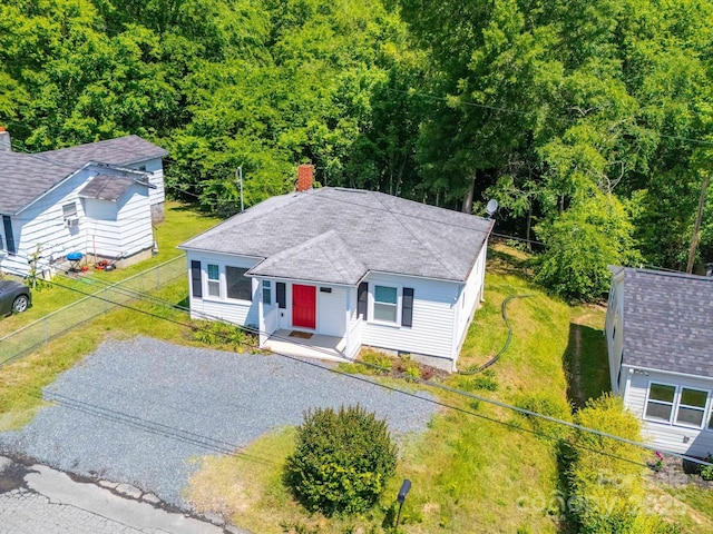 83 Woodsdale Pl SE, Concord, NC 28025 - view of front of property featuring a chimney, fence, and a shingled roof