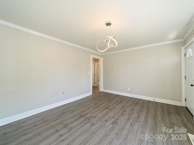 83 Woodsdale Pl SE, Concord, NC 28025 - unfurnished room featuring a chandelier, ornamental molding, baseboards, and wood finished floors