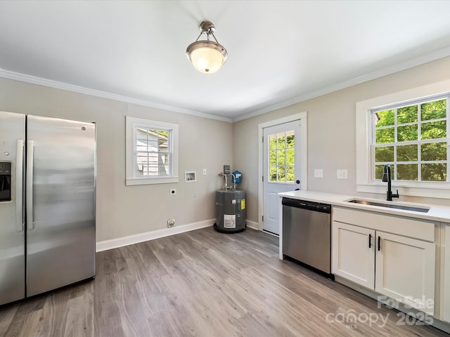 83 Woodsdale Pl SE, Concord, NC 28025 - kitchen with stainless steel appliances, a sink, light wood finished floors, crown molding, and light countertops