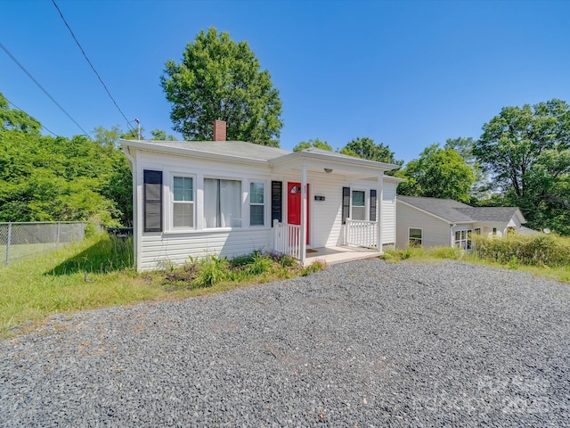 83 Woodsdale Pl SE, Concord, NC 28025 - bungalow featuring fence, driveway, a chimney, and a porch