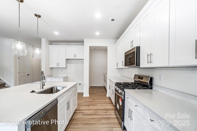 8619 Frank Grier Rd Unit 3, Charlotte, NC 28215 - kitchen featuring stainless steel appliances, a sink, light countertops, light wood-type flooring, and recessed lighting
