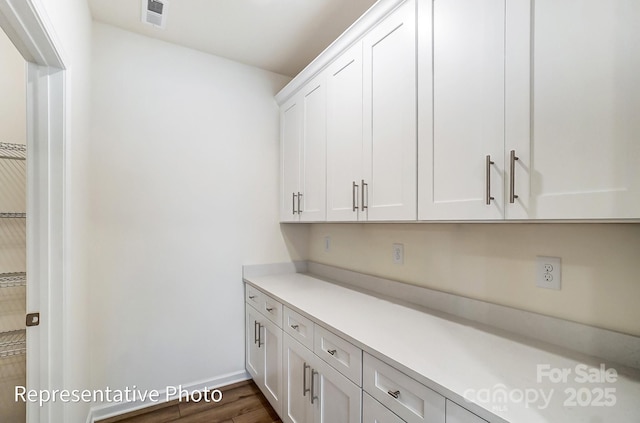 8619 Frank Grier Rd Unit 3, Charlotte, NC 28215 - kitchen with light countertops, white cabinets, dark wood finished floors, and baseboards
