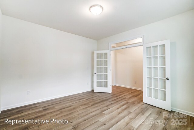 8619 Frank Grier Rd Unit 3, Charlotte, NC 28215 - spare room with french doors, wood finished floors, and baseboards