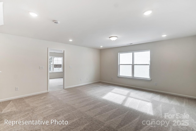 8619 Frank Grier Rd Unit 3, Charlotte, NC 28215 - empty room with light carpet, healthy amount of natural light, recessed lighting, baseboards, and a smoke detector