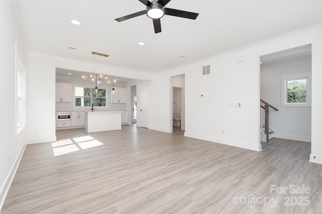 318 Sixth St, Belmont, NC 28012 - unfurnished living room with ornamental molding, a ceiling fan, stairs, recessed lighting, and baseboards