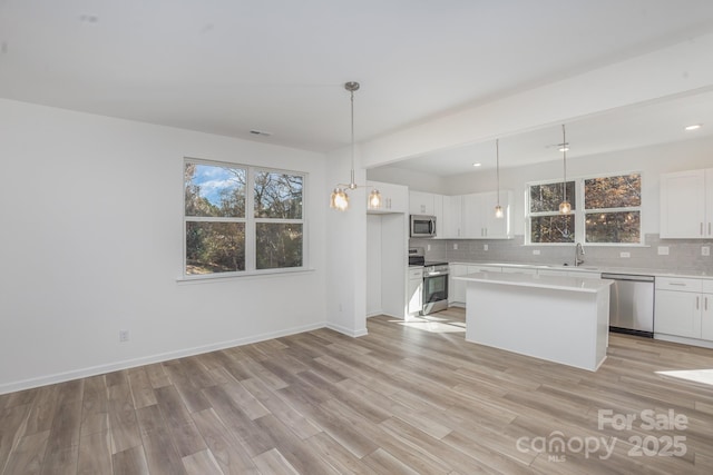 318 Sixth St, Belmont, NC 28012 - kitchen featuring stainless steel appliances, tasteful backsplash, a sink, white cabinetry, and recessed lighting