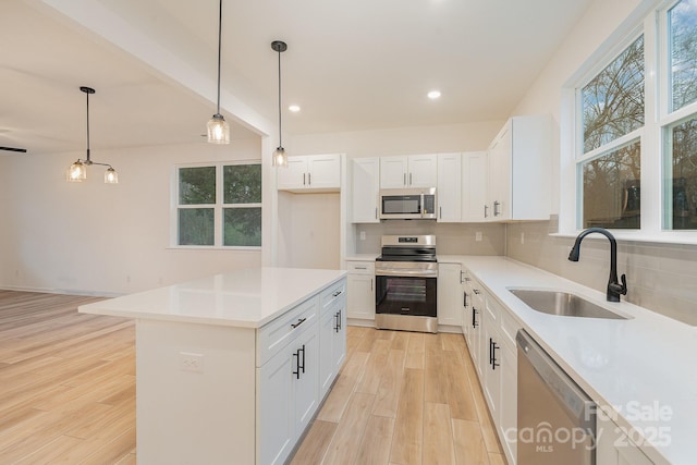 318 Sixth St, Belmont, NC 28012 - kitchen featuring stainless steel appliances, a sink, decorative backsplash, plenty of natural light, and recessed lighting