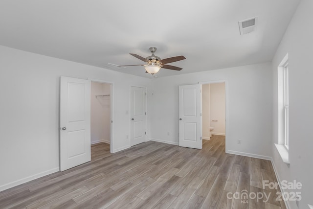 318 Sixth St, Belmont, NC 28012 - unfurnished bedroom with light wood finished floors, baseboards, a spacious closet, and a closet