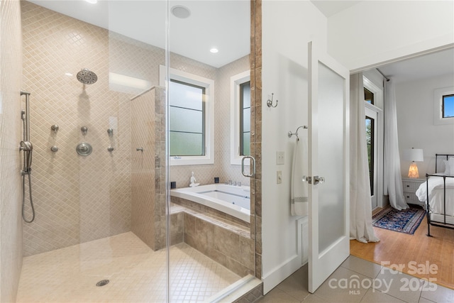 full bath with tile patterned flooring, a tile shower, a garden tub, and ensuite bath