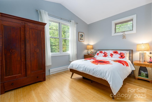 bedroom featuring light wood-style floors, lofted ceiling, and a baseboard radiator