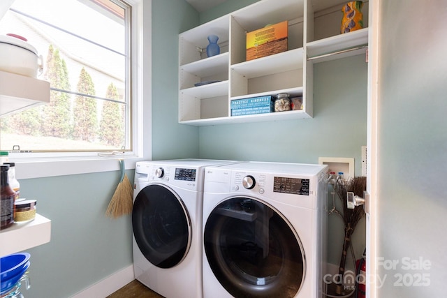 laundry area featuring washing machine and dryer and baseboards