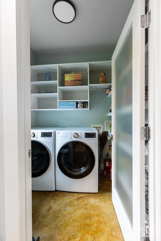 laundry room with washing machine and clothes dryer