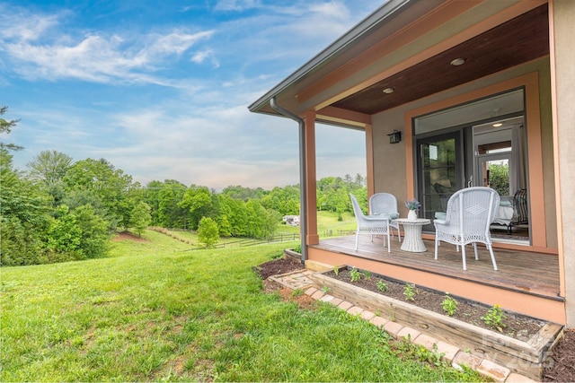 view of grassy yard with a wooden deck