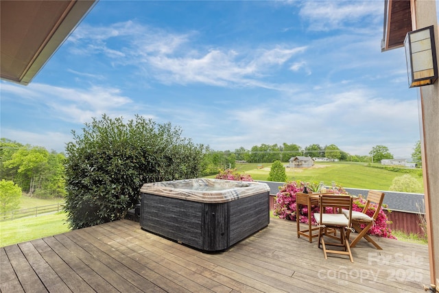 wooden terrace with a hot tub, outdoor dining space, and a yard