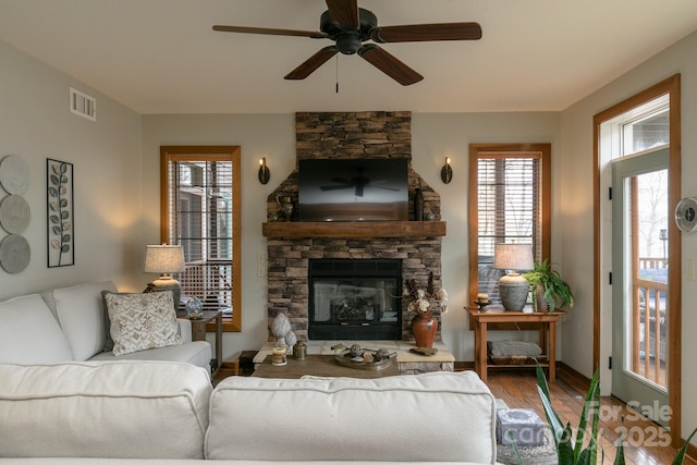 61 Creekside Way Unit G/101, Burnsville, NC 28714 - living area with wood finished floors, a fireplace, and a ceiling fan