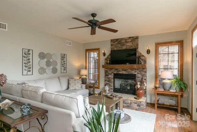 61 Creekside Way Unit G/101, Burnsville, NC 28714 - living area featuring ceiling fan, a stone fireplace, and light wood finished floors