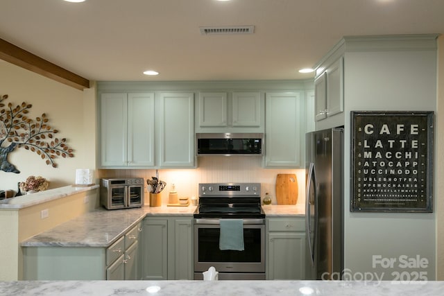 61 Creekside Way Unit G/101, Burnsville, NC 28714 - kitchen with appliances with stainless steel finishes, light stone countertops, recessed lighting, and a peninsula