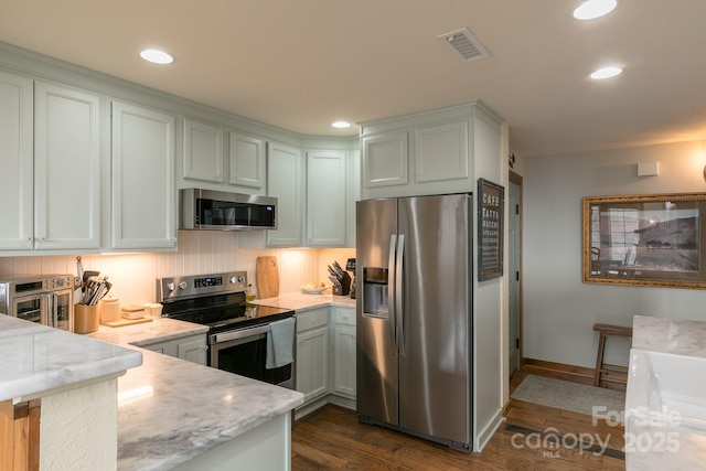61 Creekside Way Unit G/101, Burnsville, NC 28714 - kitchen with stainless steel appliances, dark wood-style floors, baseboards, recessed lighting, and light stone countertops