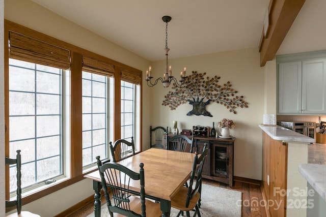 61 Creekside Way Unit G/101, Burnsville, NC 28714 - dining area with a chandelier, wood finished floors, baseboards, plenty of natural light, and beamed ceiling