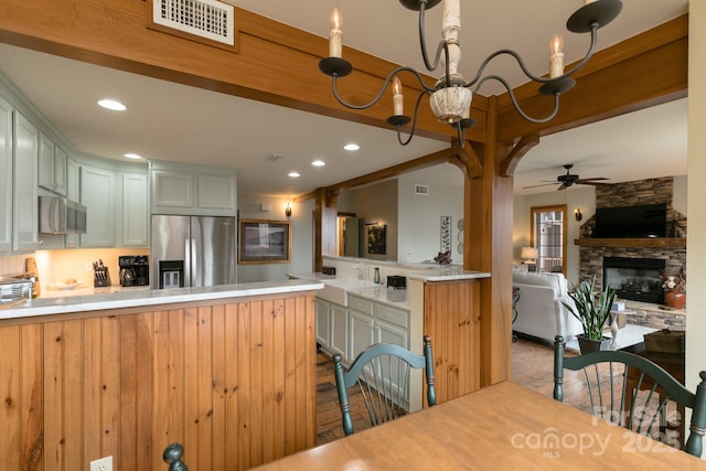 61 Creekside Way Unit G/101, Burnsville, NC 28714 - kitchen featuring stainless steel appliances, ceiling fan, a fireplace, light countertops, and recessed lighting