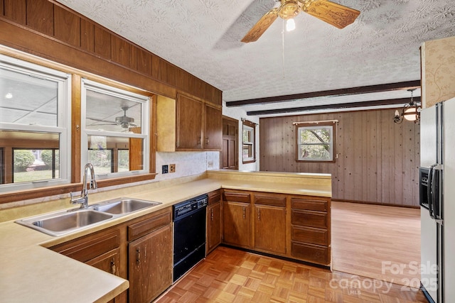 1 Ola Dr, Candler, NC 28715 - kitchen with a sink, black dishwasher, a ceiling fan, wooden walls, and light countertops