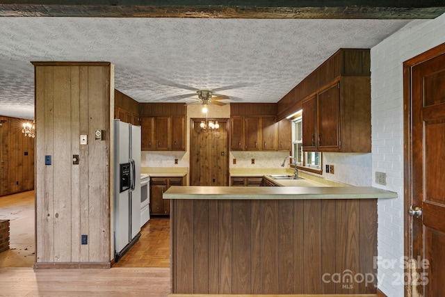 1 Ola Dr, Candler, NC 28715 - kitchen featuring a sink, white fridge with ice dispenser, light countertops, ceiling fan, and a peninsula