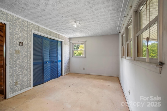 1 Ola Dr, Candler, NC 28715 - unfurnished bedroom featuring baseboards, a closet, and ornamental molding