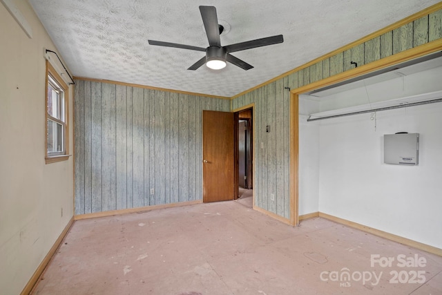 1 Ola Dr, Candler, NC 28715 - unfurnished bedroom with baseboards, a closet, crown molding, ceiling fan, and a textured ceiling